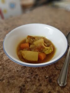 Homemade vegetable soup in bowl with spoon