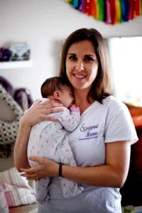 Omaha Doula Becky holding infant
